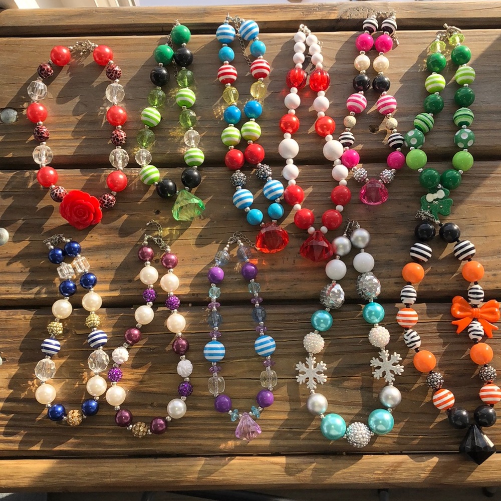Lot of 11 bubblegum necklaces.